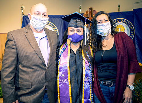 CTX parents with graduate at commencement