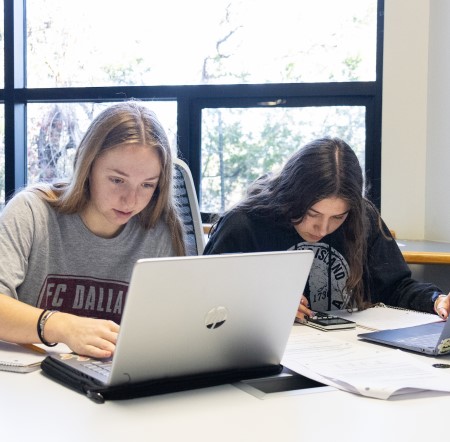 Students working in a study room on campus