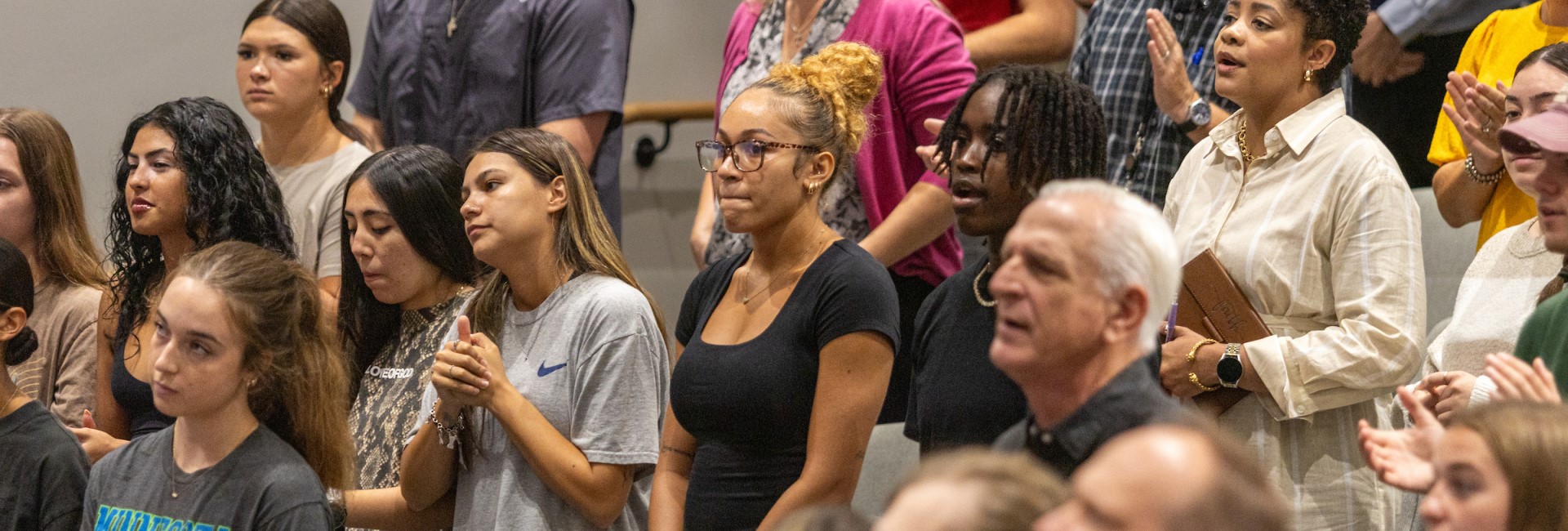 Students, Staff, and Faculty on Campus in Chapel together