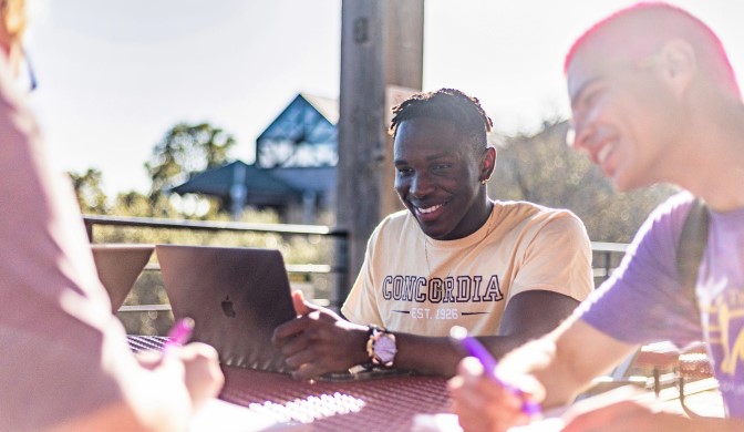 A group of Concordia students on campus working together.