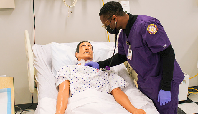 Concordia University Texas nursing student practicing on a training dummy