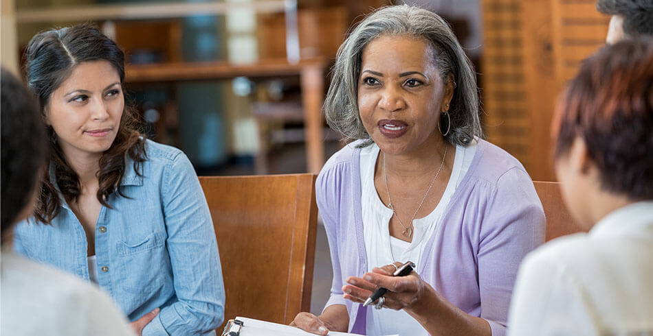 A psychologist leading a group session