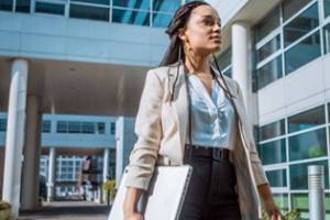 Public health professional wearing business clothes in a hospital setting.