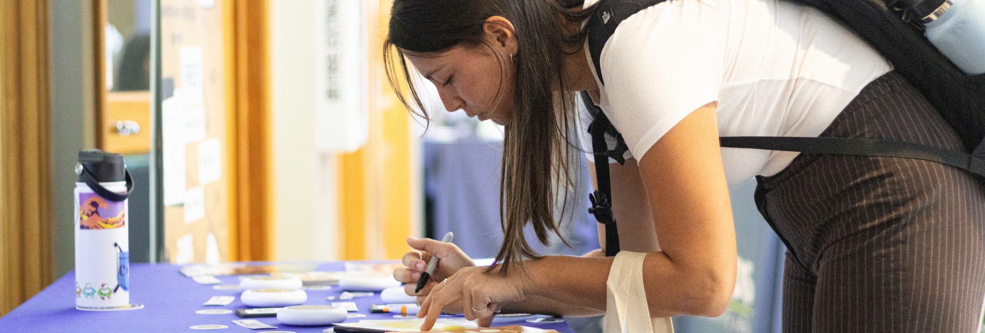A student signing some forms