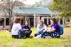 Four students collaborating on campus grounds