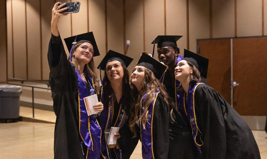 Concordia graduates taking a selfie together.