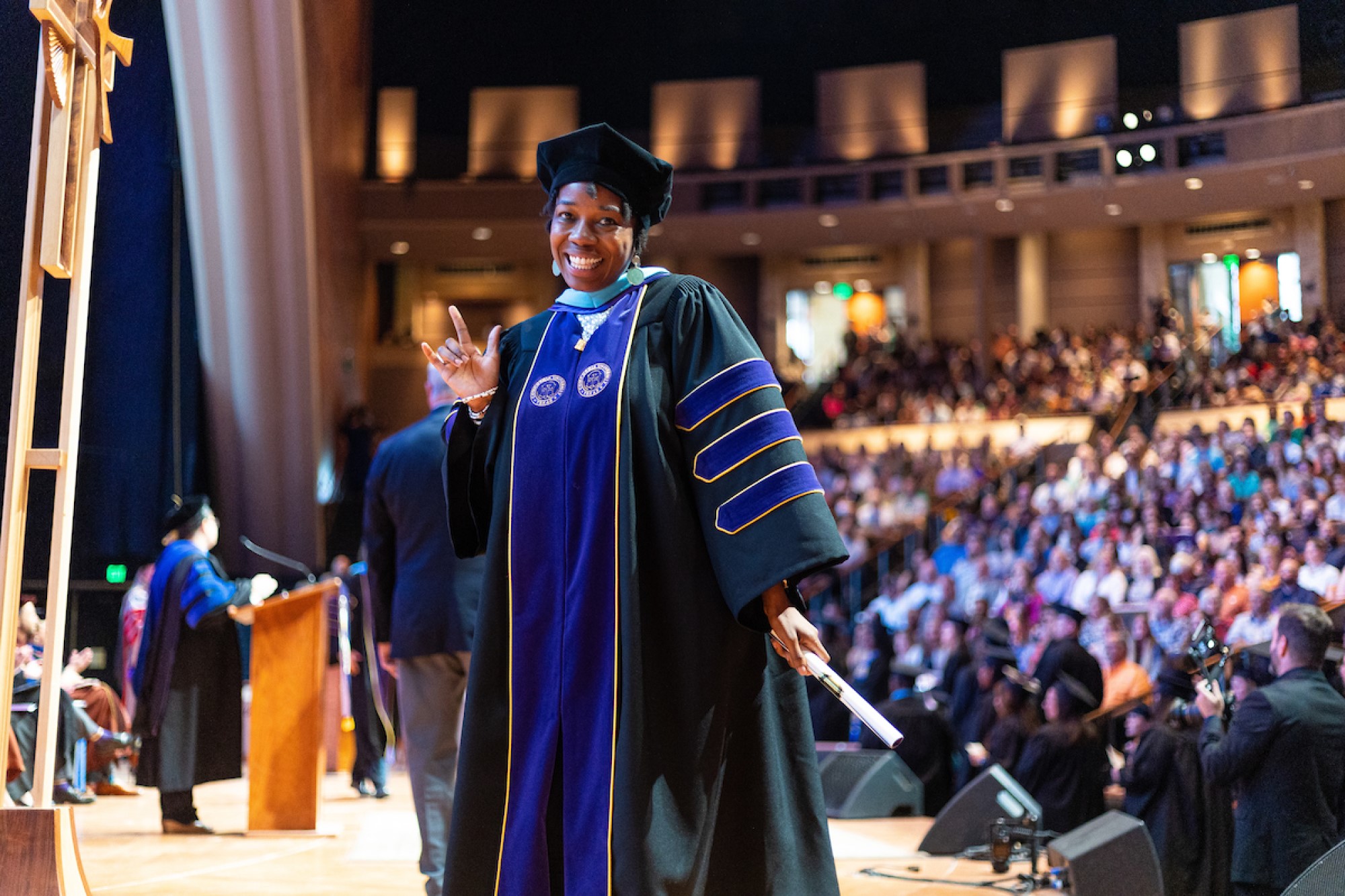 A graduate walking receiving her degree