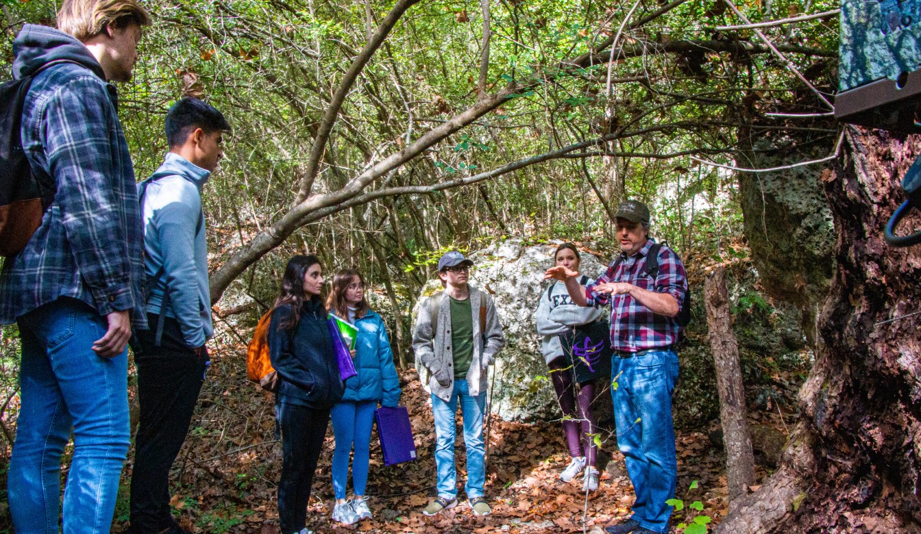 Environmental Stewardship being explained by a professor in a protected preserve.