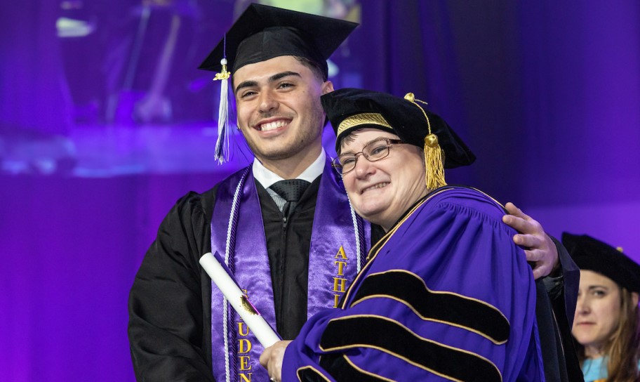 Dr. Kirk congratulating a newly graduated student.