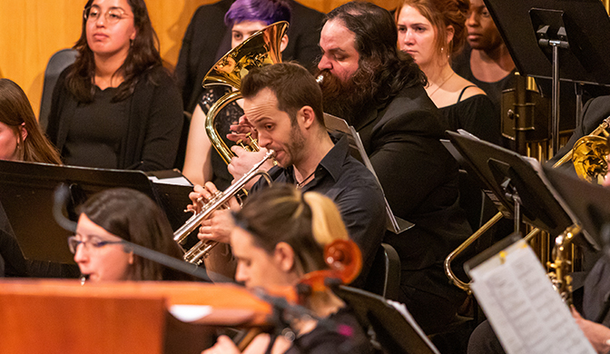 Students in the music program performing with Symphonic Winds