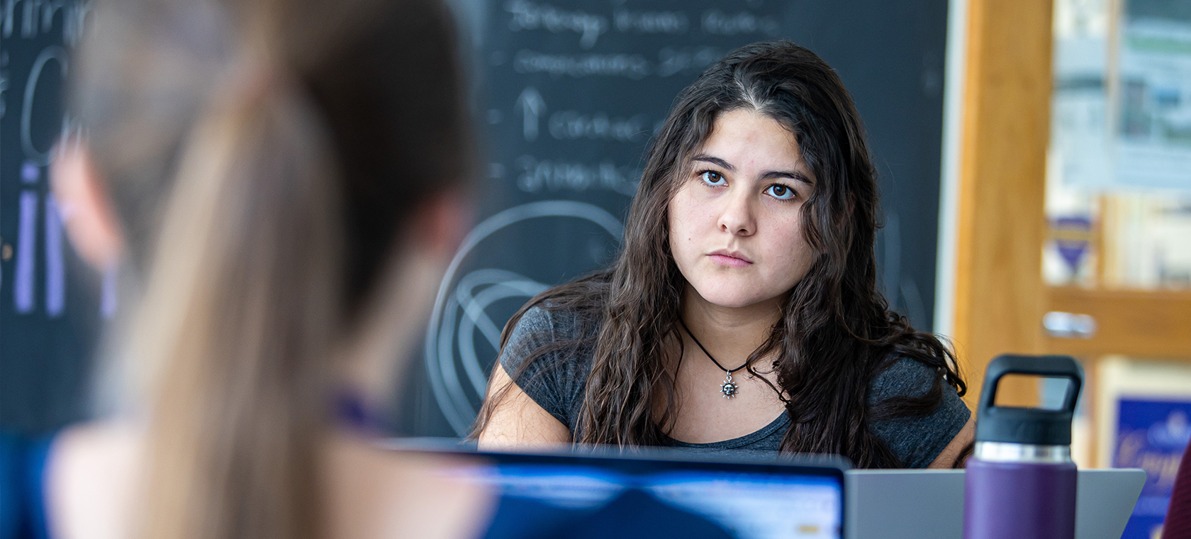 A pair of students working on a computer science project.