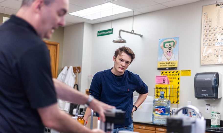 Concordia Texas chemistry professor guiding a student