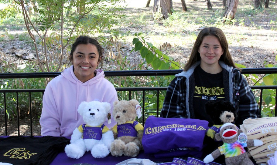 Students on campus with some bookstore swag