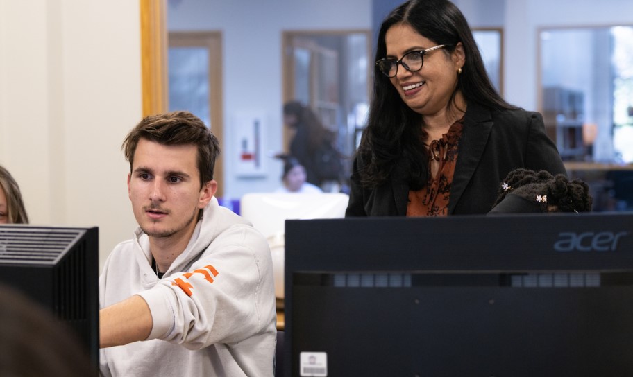 Dr. Bindu George helping students work on content