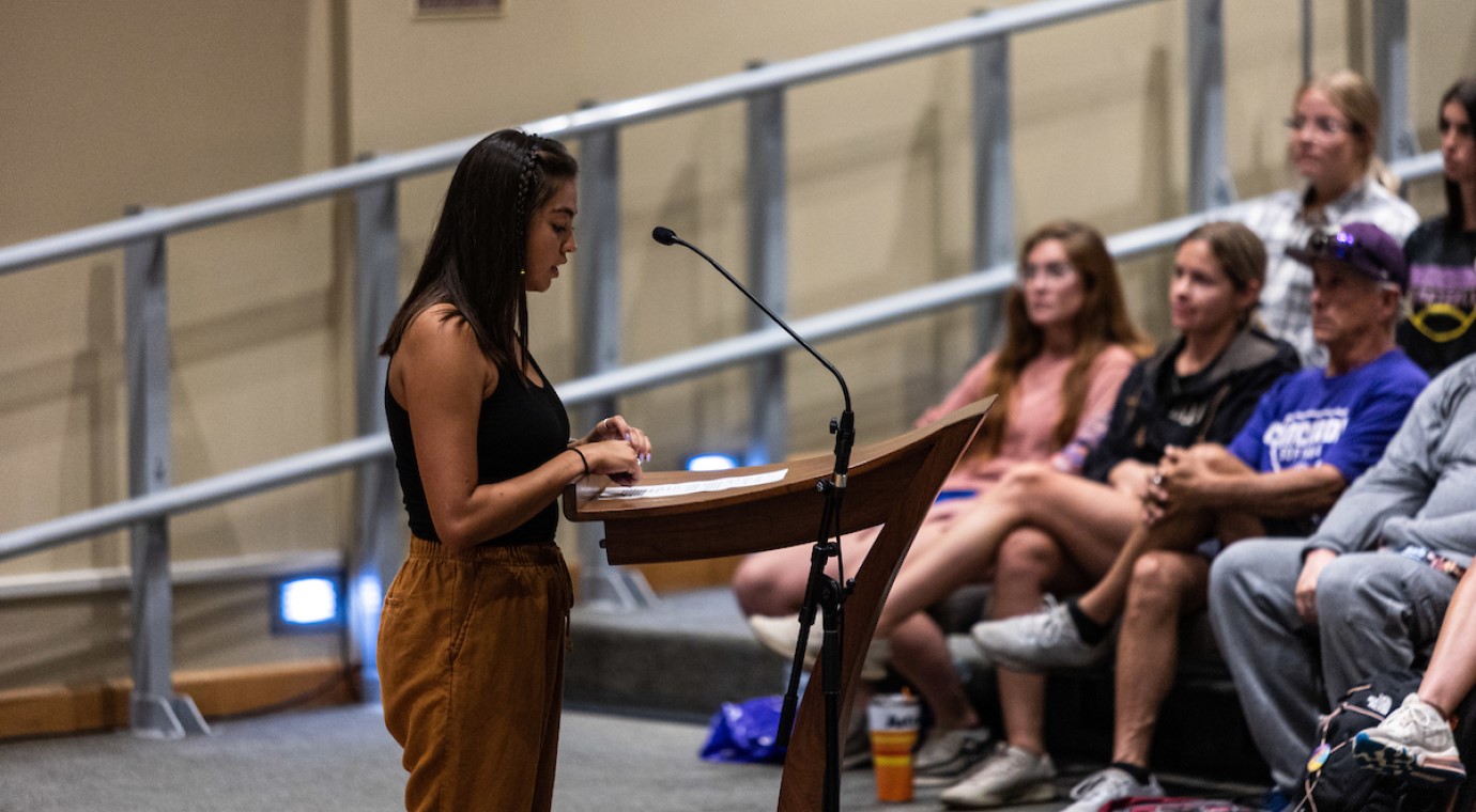 A Concordia University Texas student presenting to a large audience