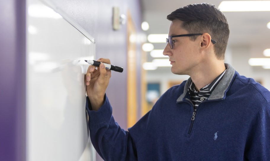 Concordia Texas student solving an equation on the board.