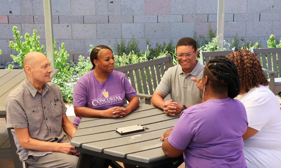 Graduate students collaborating at Purple Rock patio