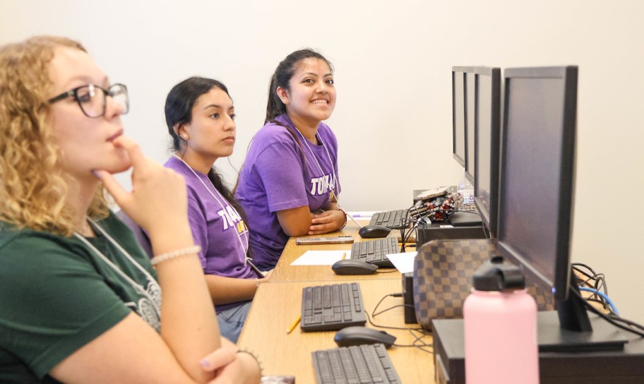 Three students in a campus computer lab