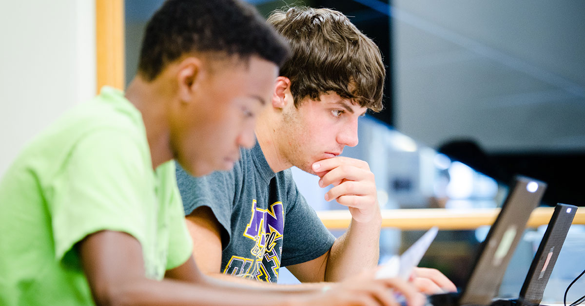 computer science students on laptops