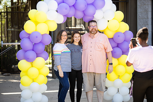 Family picture in front of balloons