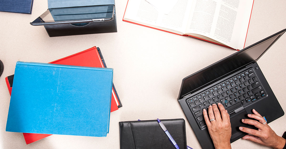 notebooks and laptop on desk