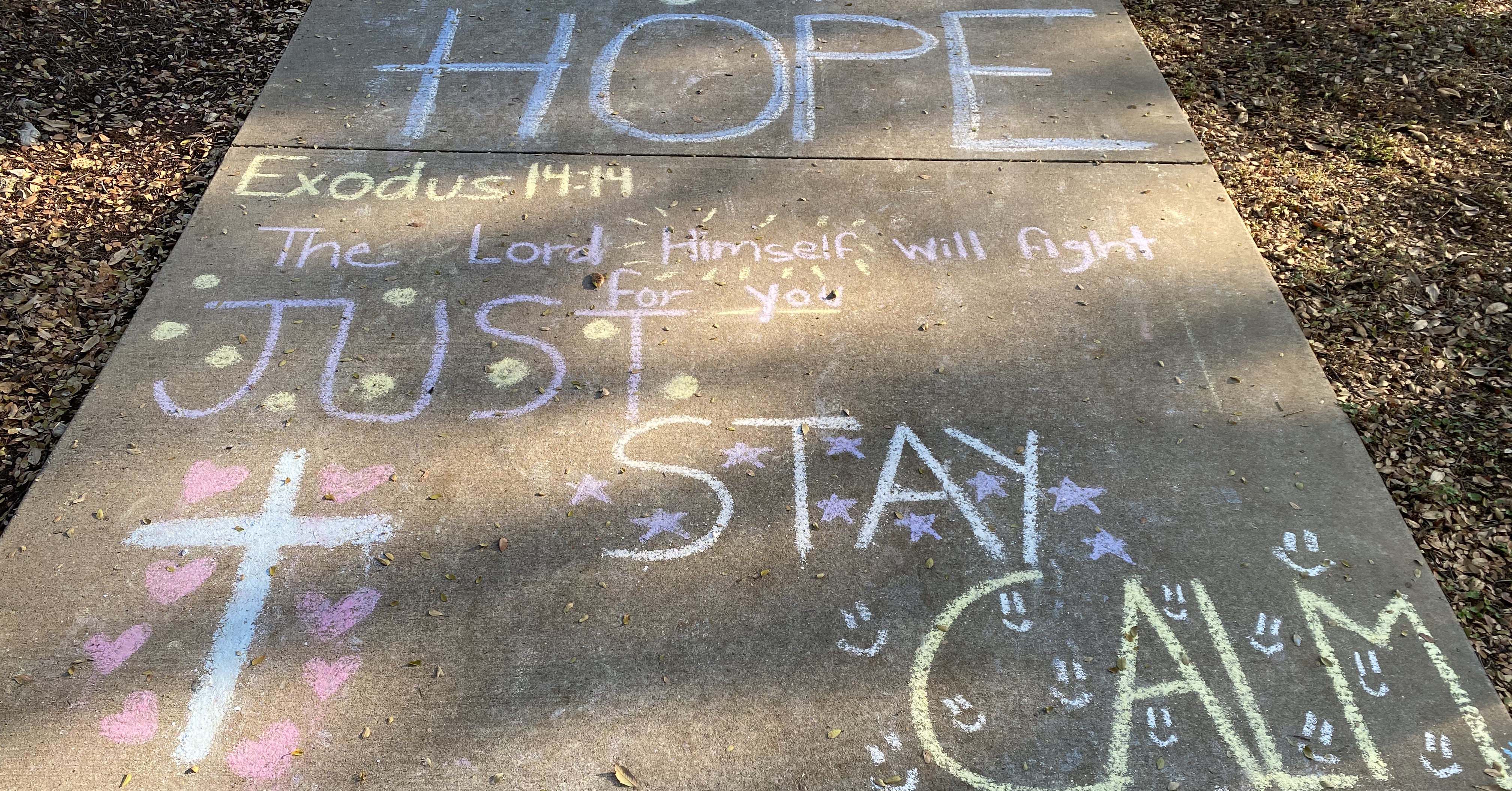 Message written on sidewalk in chalk