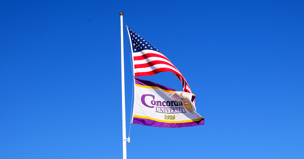 United States and Concordia University Texas flags on flagpole