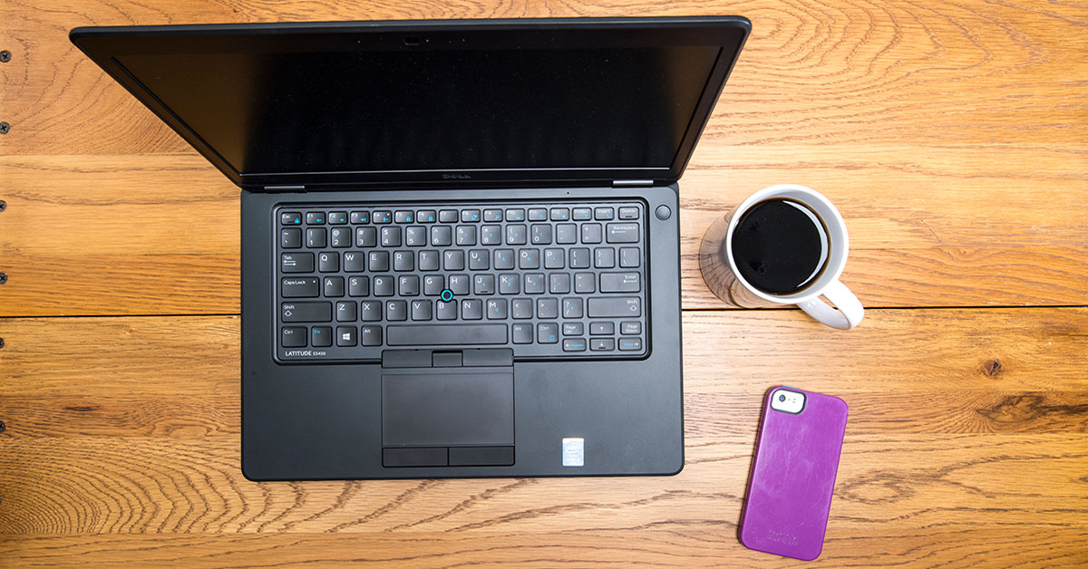laptop, cell phone, coffee on desk