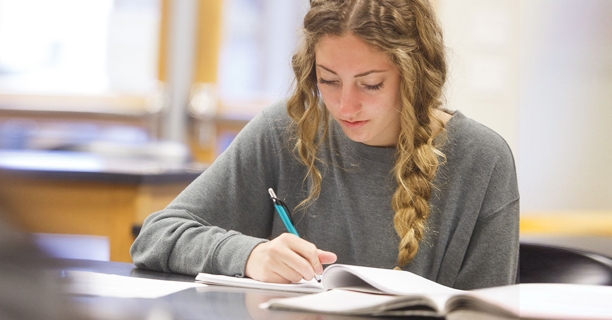 woman writing at desk