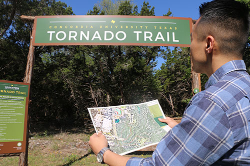 visitor with map at Tornado Trail