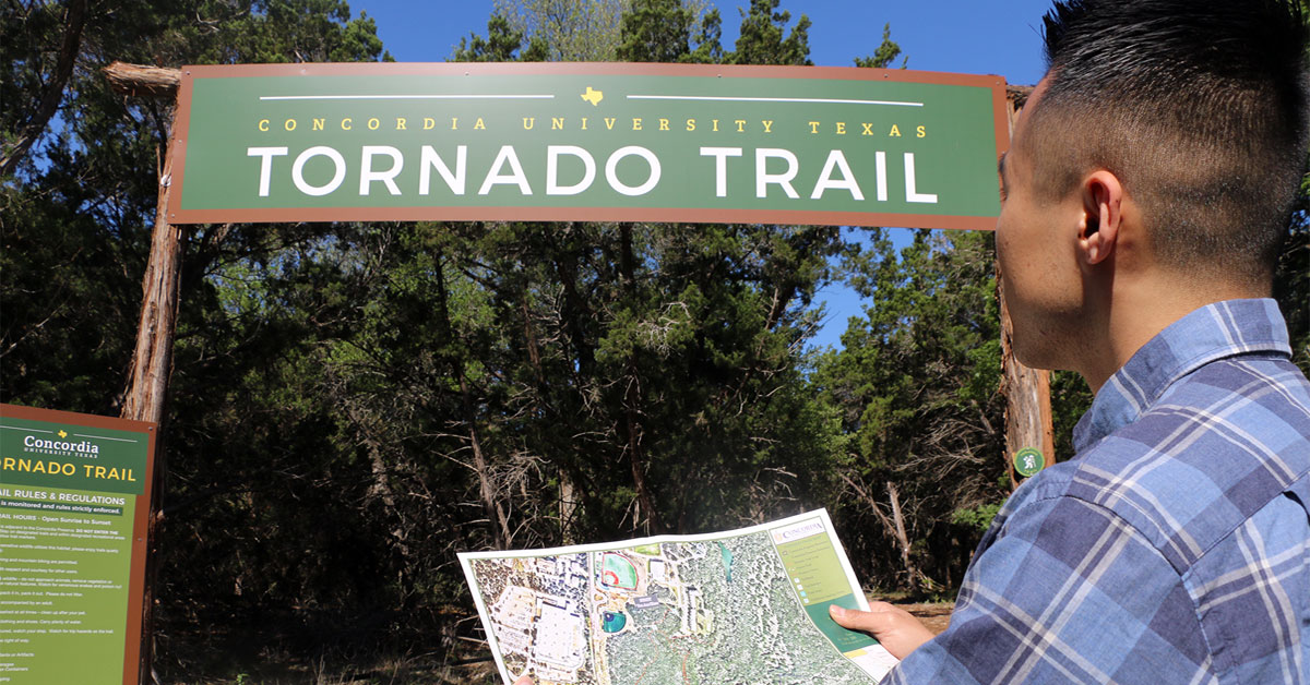 visitor with map at Tornado Trail entrance