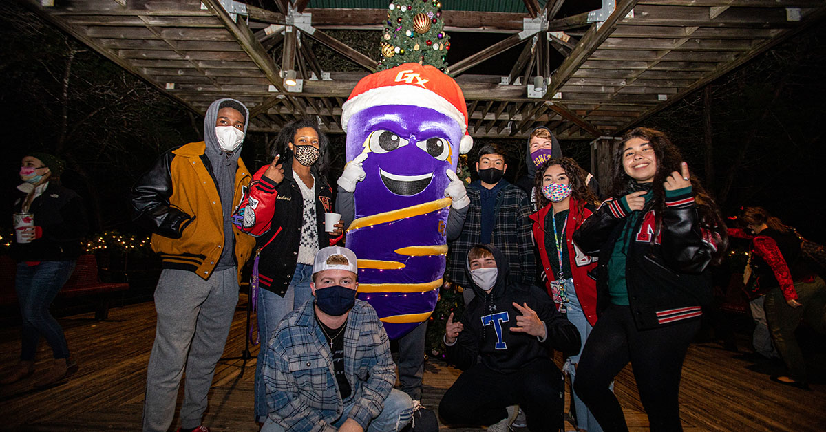 Group photo with vortex and students in front of Christmas tree