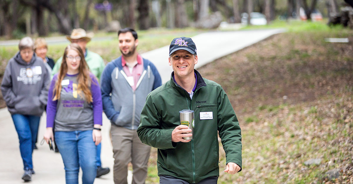 Zach Stark with students on campus