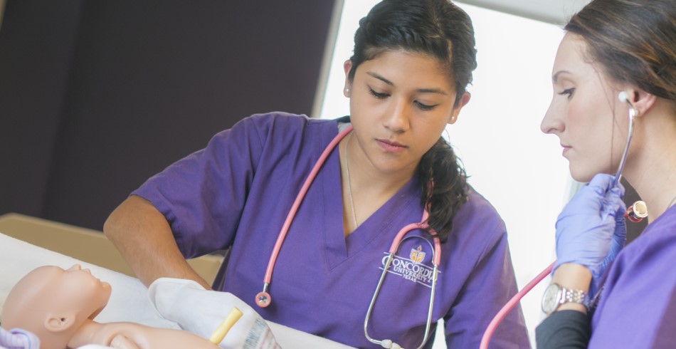 Nursing students learning in a sim lab.