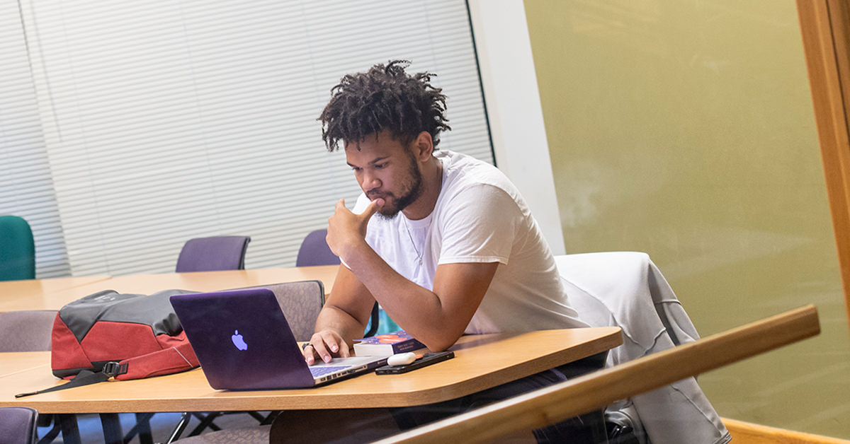 CTX Student Looking at Laptop