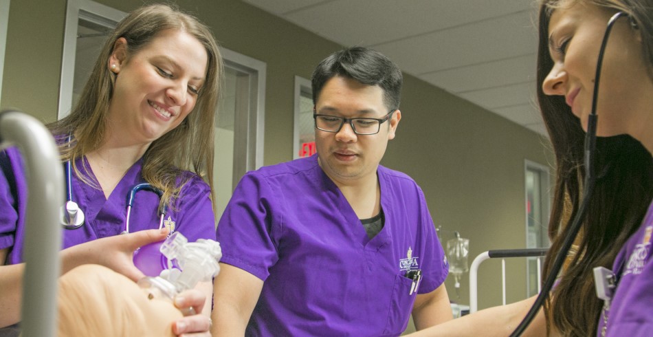 A trio of Concordia University Texas nursing students practicing with a simulated patient