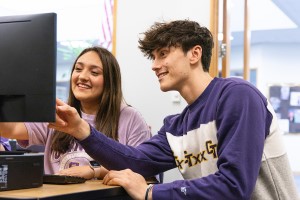 Two students collaborating with each other in the classroom