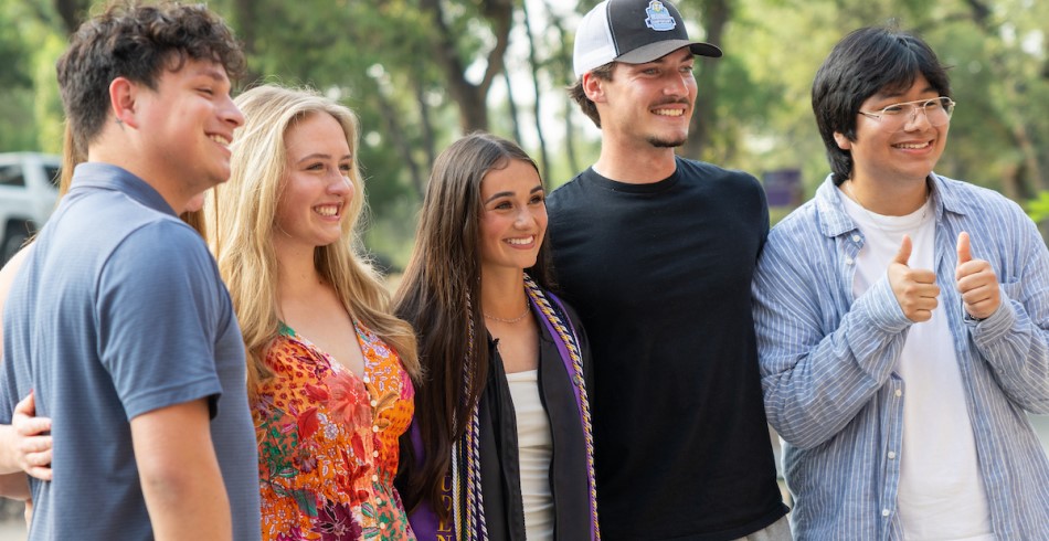  Concordia University Texas student celebrating graduation on campus in Austin