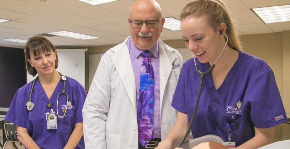 A nursing student in sim with her instructors