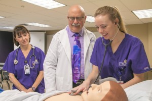 A nursing student in sim with her instructors