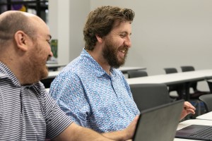 Graduate student working with technology in a collaborative setting