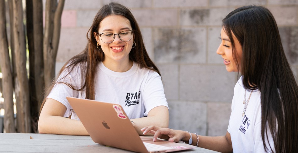 A pair of Concordia University Texas students working together on campus