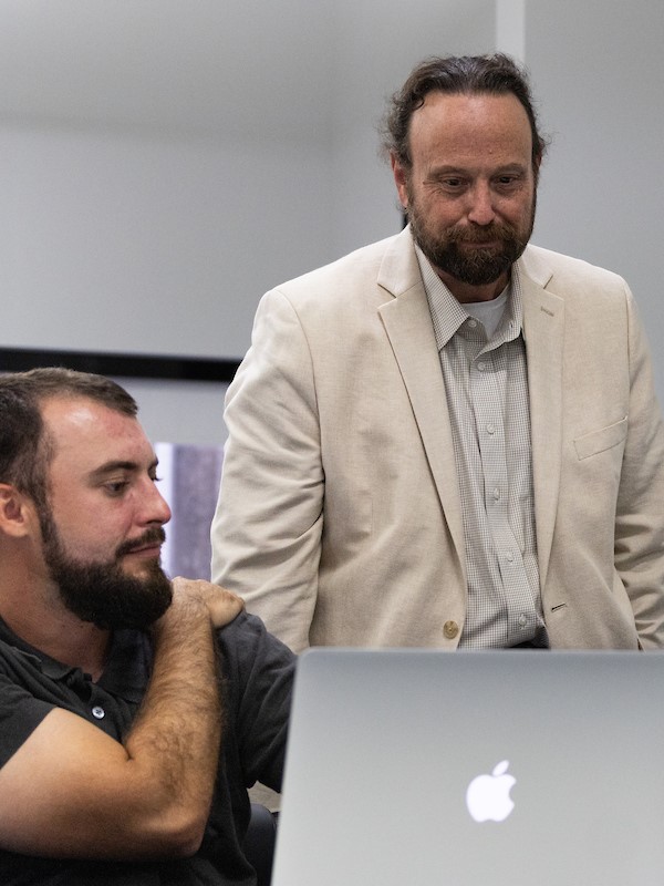 Dr. Chris Putnam assisting his students during the residency weekend. 