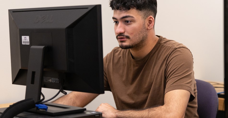 A student working on an MCS project in a computer lab