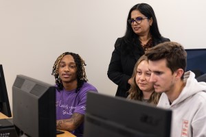 Dr. George helping students in a computer lab