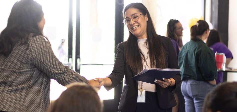 Students meeting with a professor on campus