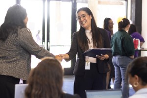Students meeting with a professor on campus