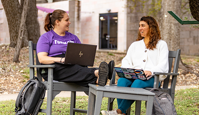 A pair of students relaxing on campus