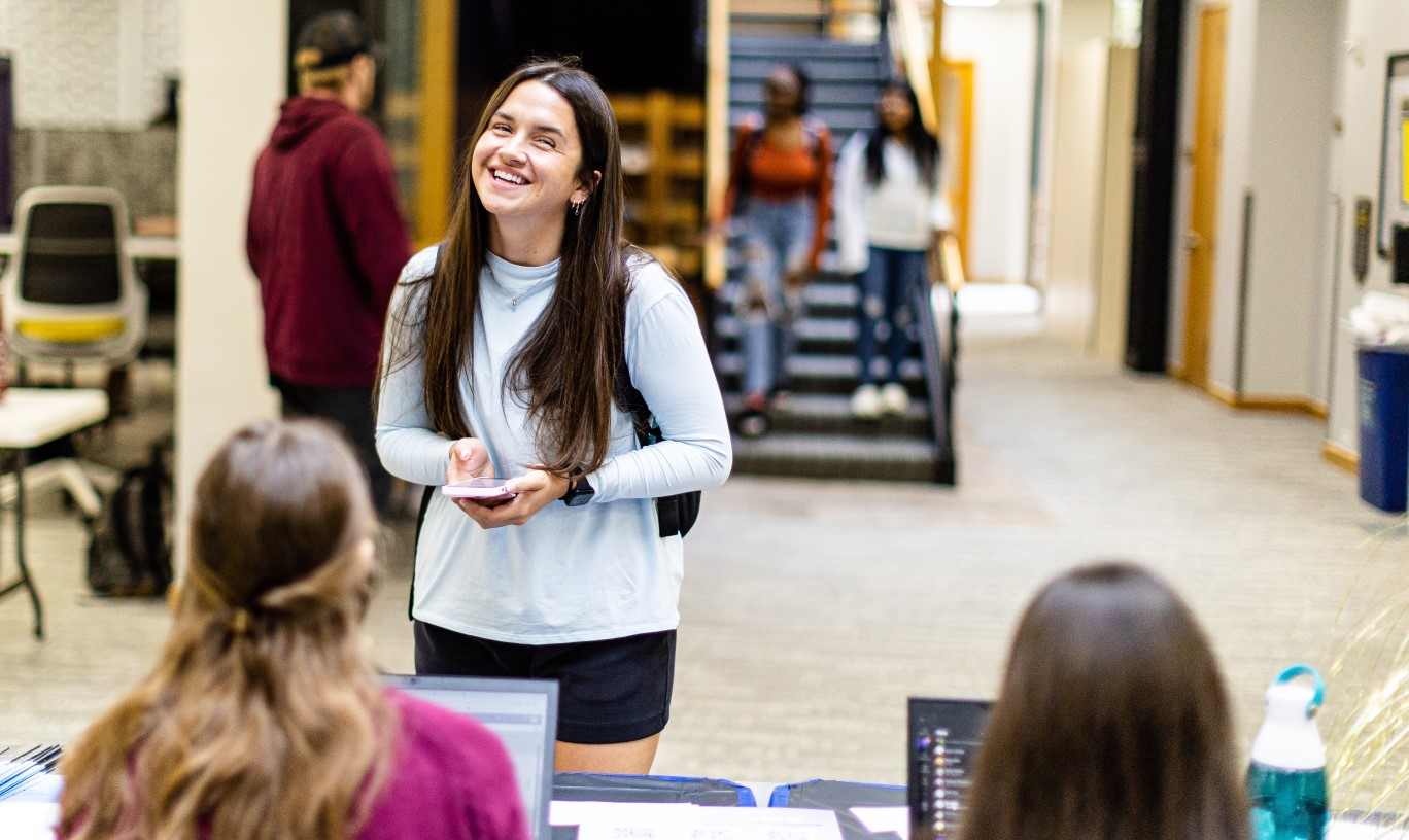 A student in front of a panel