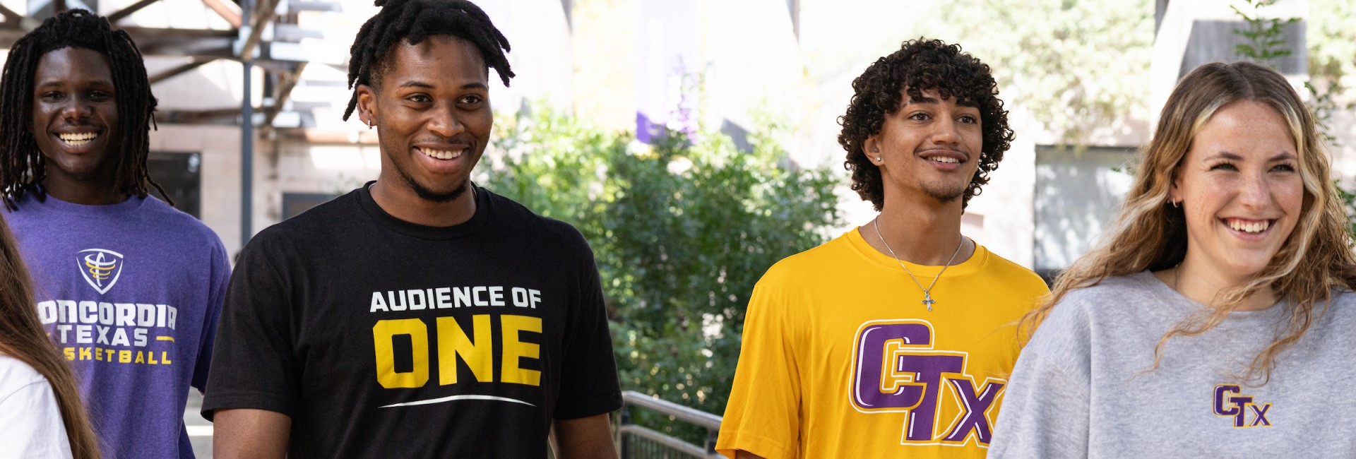 Concordia Texas student-athletes from several sports gathered on campus or walking together toward an athletics facility